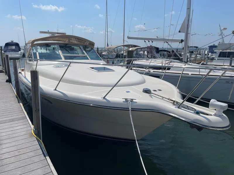 Slide: The Image of 1998 Tiara Yachts 3500 Open docked at marina under clear sky. - 2
