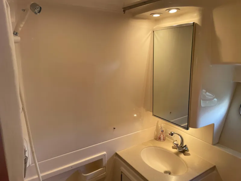 Slide: The Image of Bathroom interior of 1998 Tiara Yachts 3500 Open, featuring sink, mirror, and showerhead. - 20