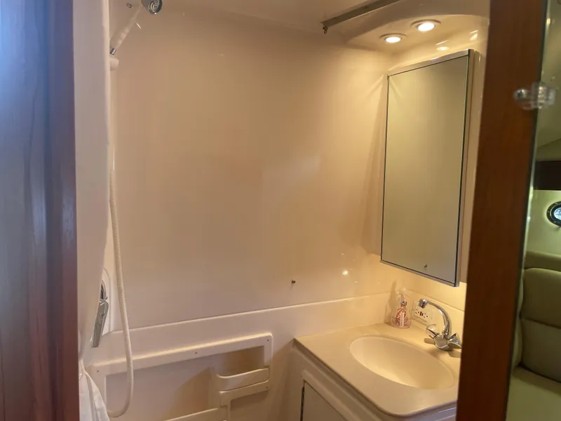 Slide: The Image of 1998 Tiara Yachts 3500 Open bathroom with sink, mirror, and shower. - 21