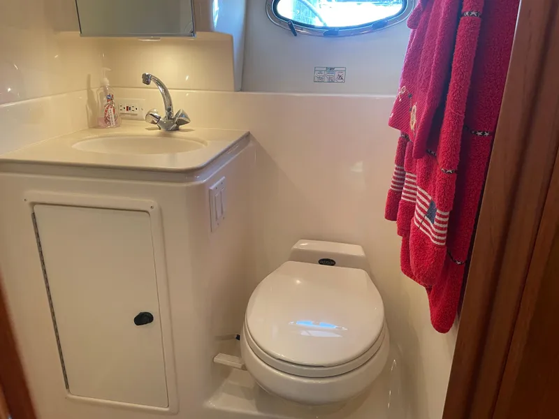 Slide: The Image of Bathroom interior of 1998 Tiara Yachts 3500 Open, featuring sink and toilet. - 22