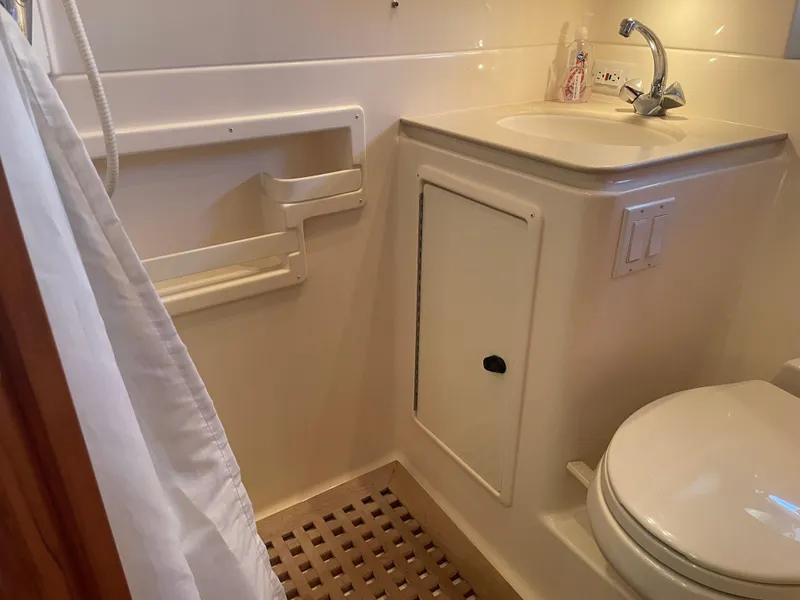 Slide: The Image of Bathroom interior of 1998 Tiara Yachts 3500 Open, featuring sink and toilet. - 23