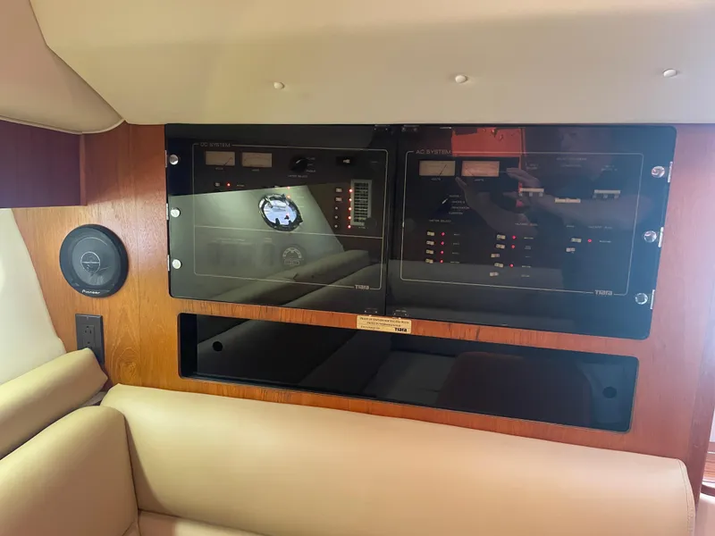 Slide: The Image of Control panel of a 1998 Tiara Yachts 3500 Open, featuring AC and DC systems. - 24
