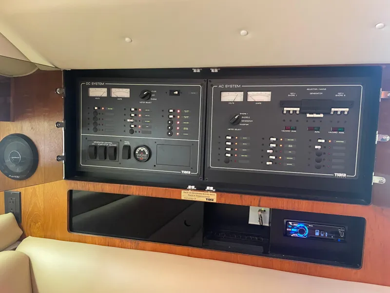 Slide: The Image of 1998 Tiara Yachts 3500 Open electrical control panel with DC and AC systems. - 25