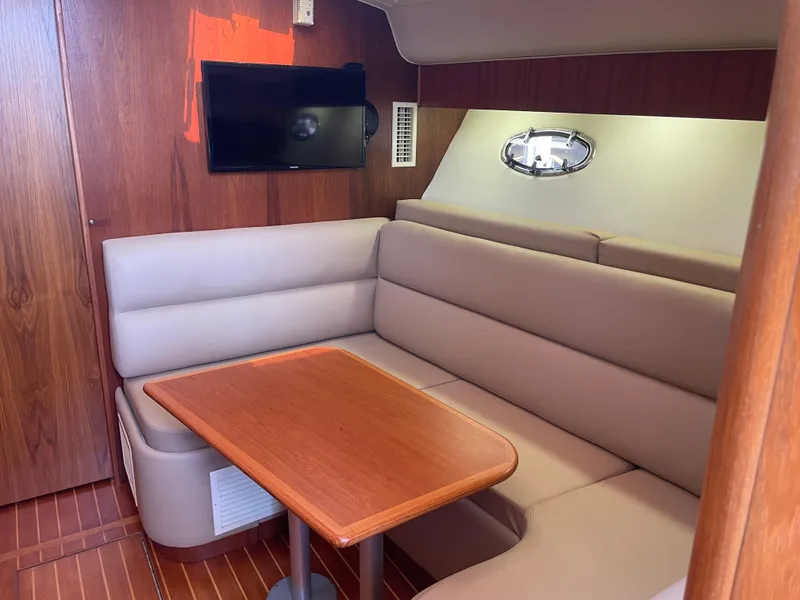 Slide: The Image of Interior of 1998 Tiara Yachts 3500 Open with cozy seating and wooden table. - 26