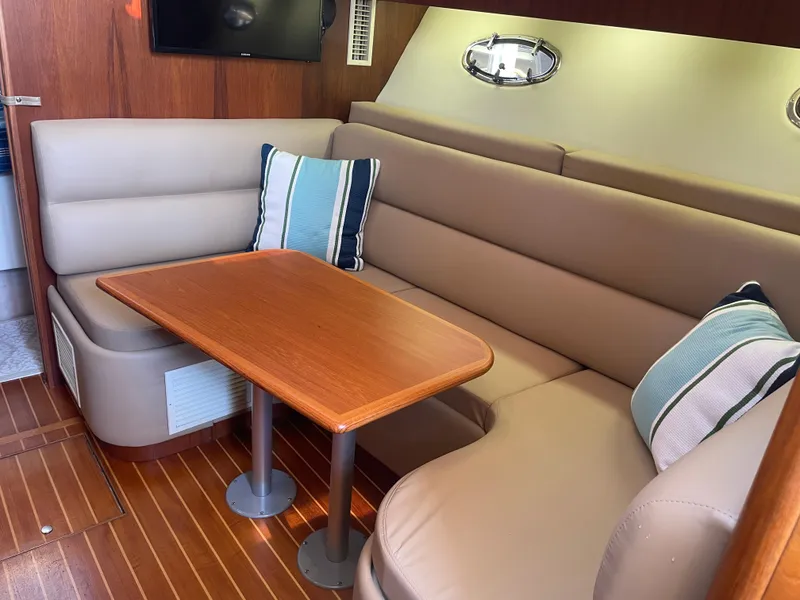 Slide: The Image of Luxurious interior of 1998 Tiara Yachts 3500 Open with cozy seating and wooden table. - 27