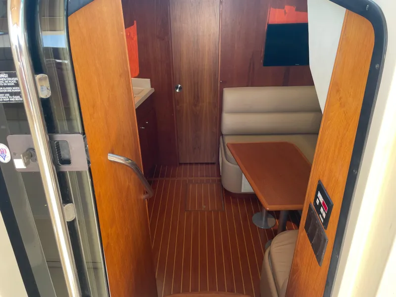 Slide: The Image of 1998 Tiara Yachts 3500 Open interior with wood finish and seating area. - 33