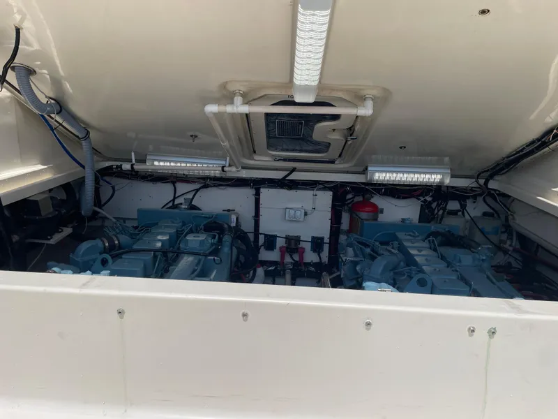 Slide: The Image of Engine compartment of a 1998 Tiara Yachts 3500 Open, showcasing dual engines and wiring. - 34