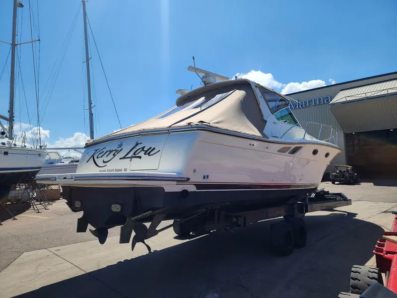 Slide: The Image of 1998 Tiara Yachts 3500 Open on trailer at marina under clear blue sky. - 39