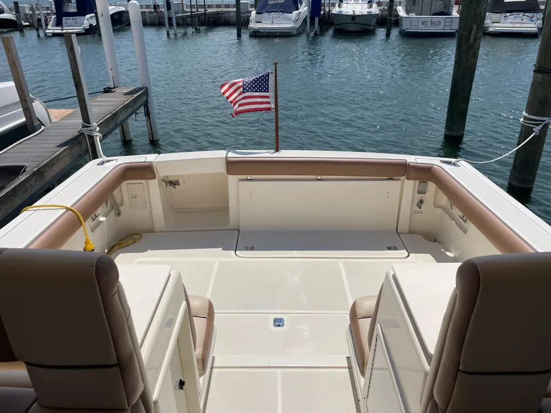 Slide: The Image of 1998 Tiara Yachts 3500 Open boat with American flag, docked at marina. - 5