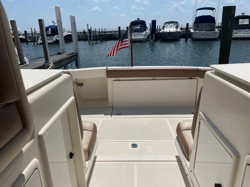 Slide: The Image of 1998 Tiara Yachts 3500 Open at dock, featuring spacious deck and American flag. - 7