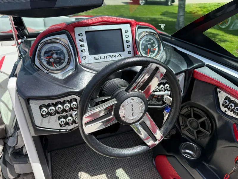 Slide: The Image of 2015 Supra SE450-550 boat dashboard with steering wheel and control panel. - 10