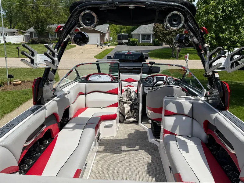 Slide: The Image of 2015 Supra SE450-550 boat interior with red and white seating, speakers, and modern dashboard. - 11