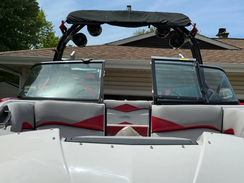 Slide: The Image of 2015 Supra SE450-550 boat interior with red and gray seating, open windshield, and speakers. - 7