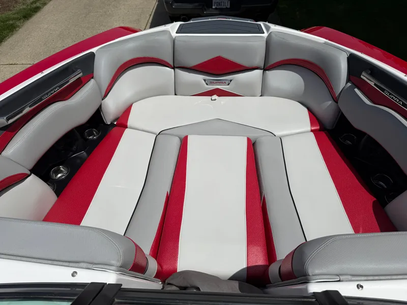 Slide: The Image of 2015 Supra SE450-550 boat interior with red and white seating, showcasing luxury design. - 9