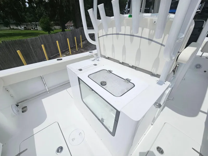 Slide: The Image of 2025 Sea Hunt Gamefish 28 FS boat deck with fishing rod holders and storage. - 14