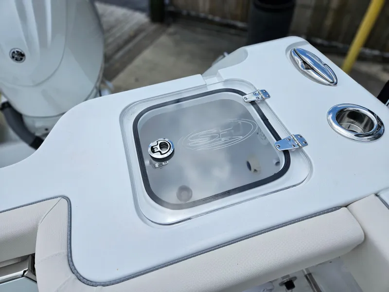Slide: The Image of 2025 Sea Hunt Gamefish 28 FS boat detail with storage compartment and cup holders. - 16