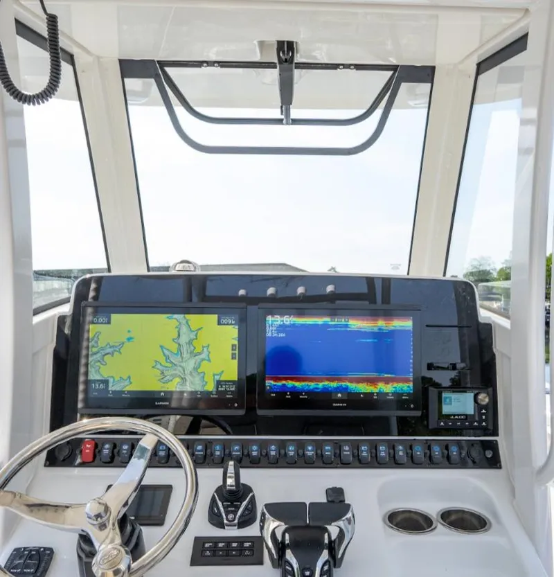 Slide: The Image of 2025 Sea Hunt Gamefish 28 FS dashboard with navigation screens and controls. - 17