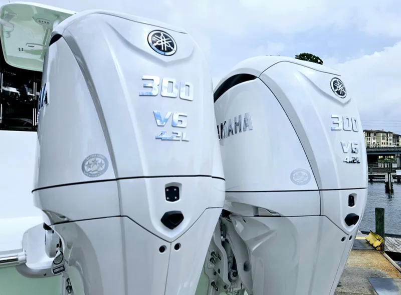 Slide: The Image of Twin Yamaha 300 V6 outboard engines on a 2025 Sea Hunt Gamefish 28 FS boat. - 2