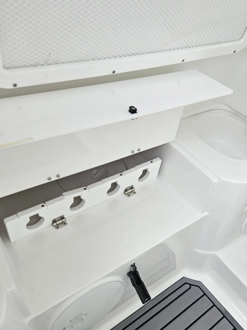 Slide: The Image of 2025 Sea Hunt Gamefish 28 FS interior storage compartment with rod holders. - 25
