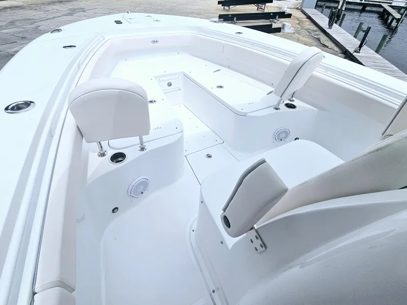 Slide: The Image of 2025 Sea Hunt Gamefish 28 FS boat interior with white seating and spacious deck. - 26