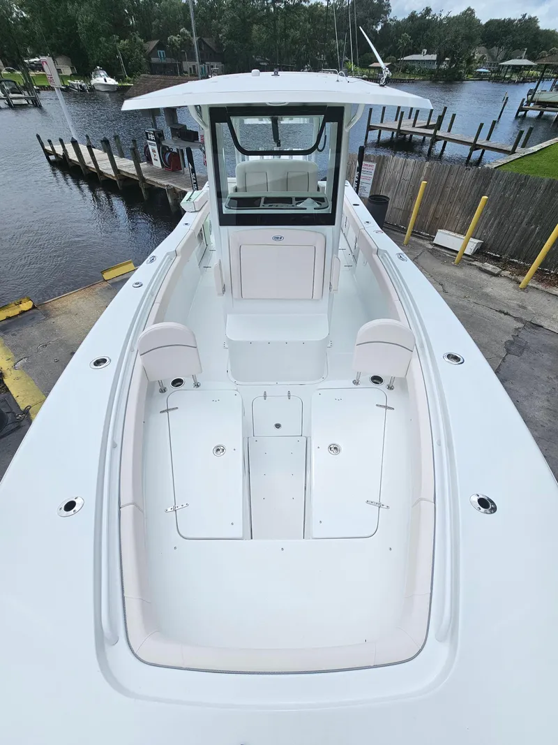 Slide: The Image of 2025 Sea Hunt Gamefish 28 FS boat docked at marina, aerial view. - 28