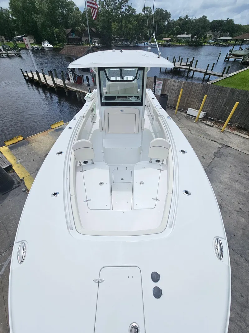 Slide: The Image of 2025 Sea Hunt Gamefish 28 FS boat docked at a marina. - 3