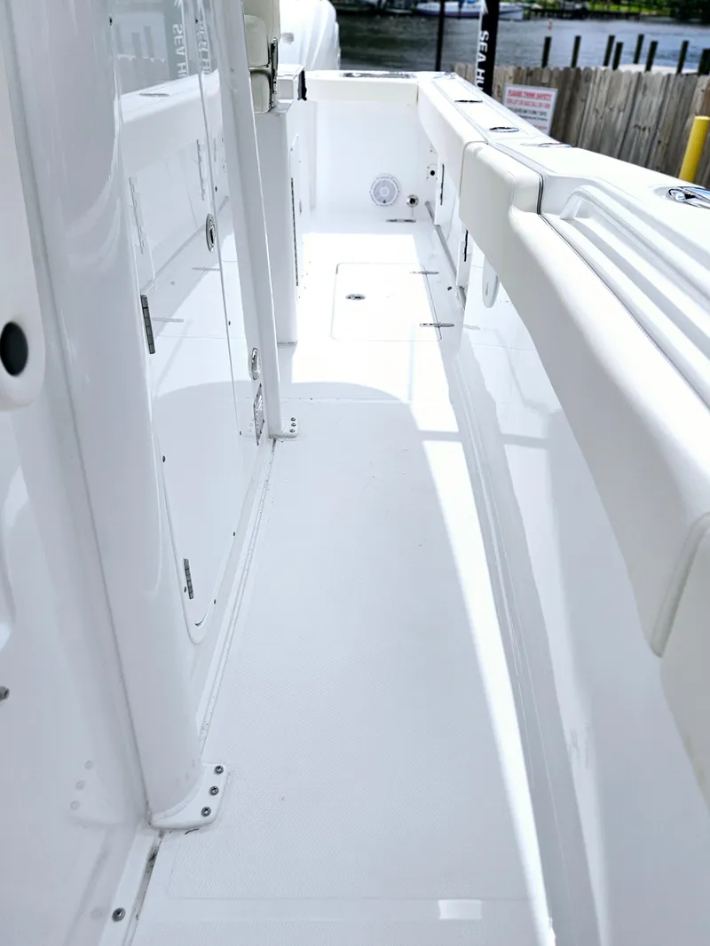 Slide: The Image of 2025 Sea Hunt Gamefish 28 FS boat interior, featuring sleek white deck and seating. - 34