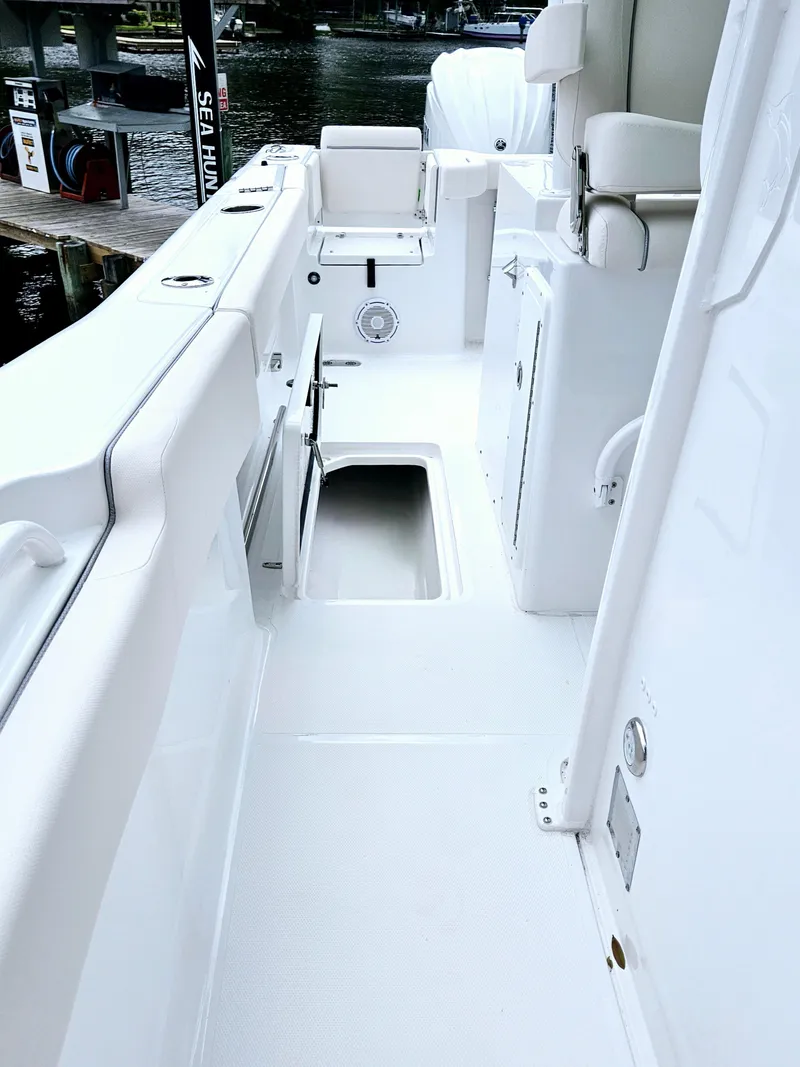 Slide: The Image of 2025 Sea Hunt Gamefish 28 FS boat interior, featuring sleek white deck design. - 36