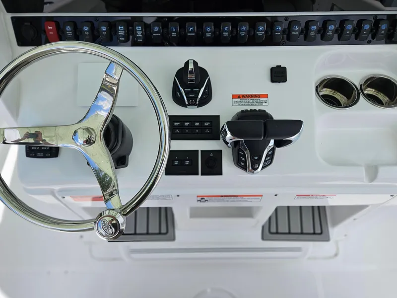 Slide: The Image of 2025 Sea Hunt Gamefish 28 FS helm with steering wheel and controls. - 20