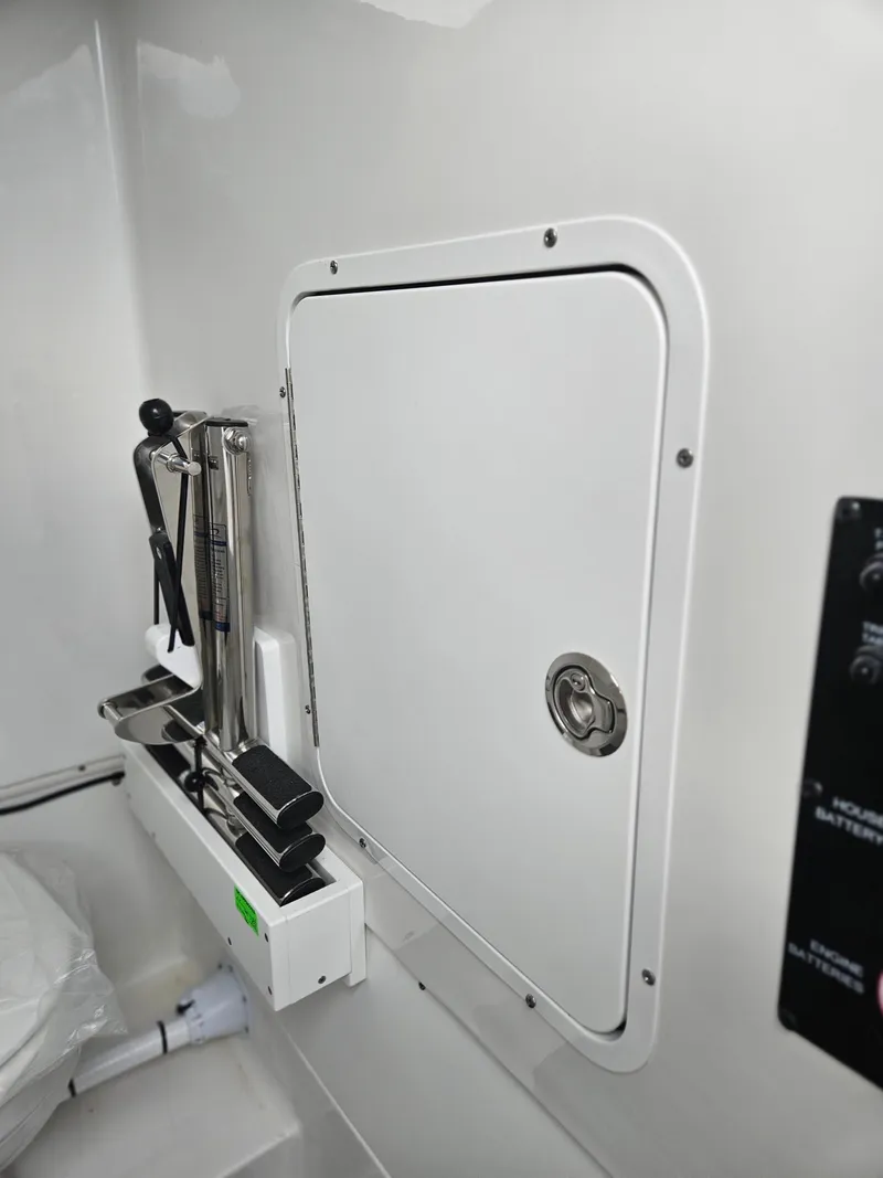 Slide: The Image of 2025 Sea Hunt Gamefish 28 FS interior storage compartment with fishing rod holders. - 23