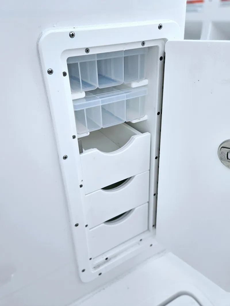 Slide: The Image of 2025 Sea Hunt Gamefish 28 FS tackle storage compartment with drawers and shelves. - 31