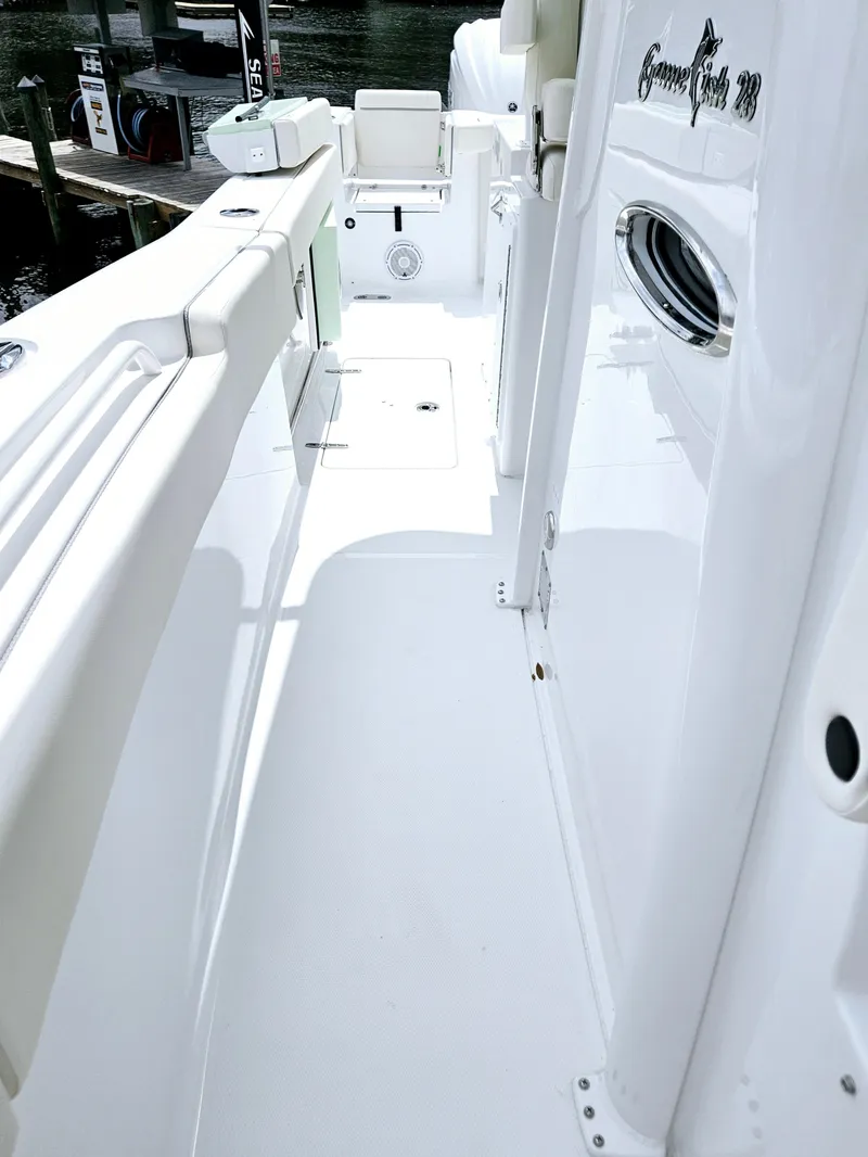 Slide: The Image of 2025 Sea Hunt Gamefish 28 FS boat deck, sleek white design, spacious layout. - 35