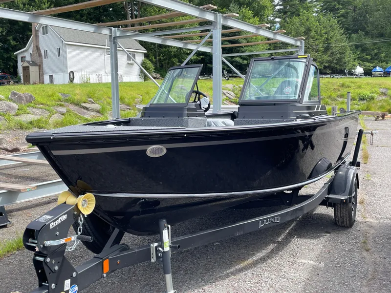 The Image of 2026 Lund 1800 Explorer Sport boat on trailer, parked outdoors. - 0