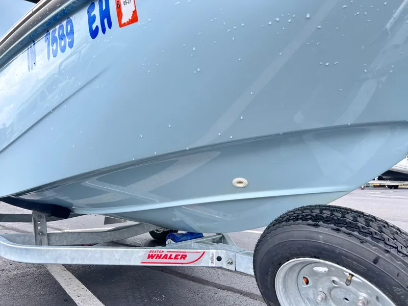 Slide: The Image of 2022 Boston Whaler 130 Super Sport boat on trailer, close-up view. - 13