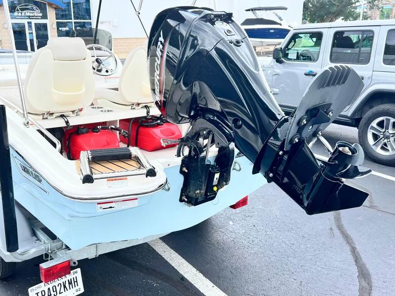 Slide: The Image of 2022 Boston Whaler 130 Super Sport with Mercury outboard motor, parked in a lot. - 4