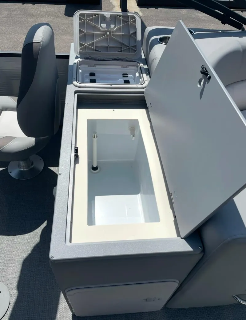 Slide: The Image of 2021 Manitou 24 Encore Pro Angler PT boat interior with open storage compartments. - 3