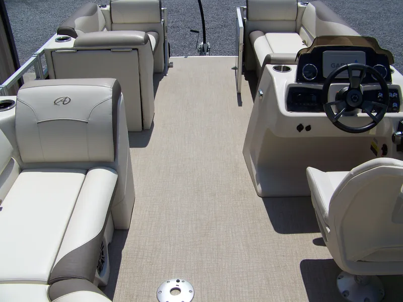Slide: The Image of 2023 Avalon Venture Rear Fish 20' boat interior with beige seating and steering console. - 11