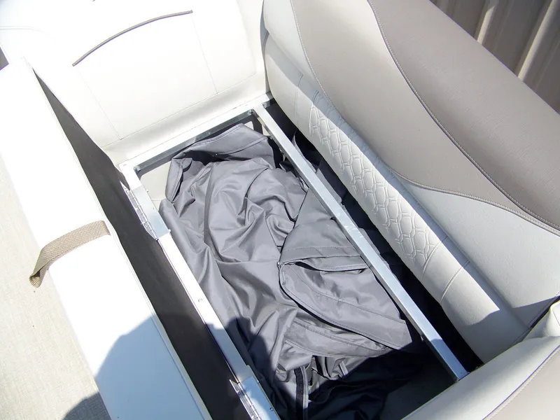 Slide: The Image of 2023 Avalon Venture Rear Fish boat seat storage compartment with cover inside. - 4