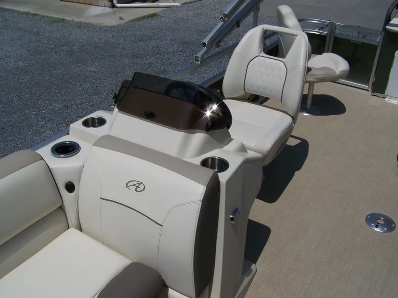 Slide: The Image of 2023 Avalon Venture Rear Fish boat interior with beige seating and console. - 5
