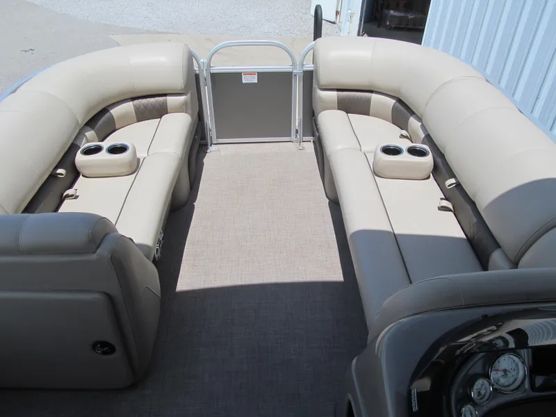 Slide: The Image of 2023 Sun Tracker Party Barge 20 DLX interior with beige seating and cup holders. - 7