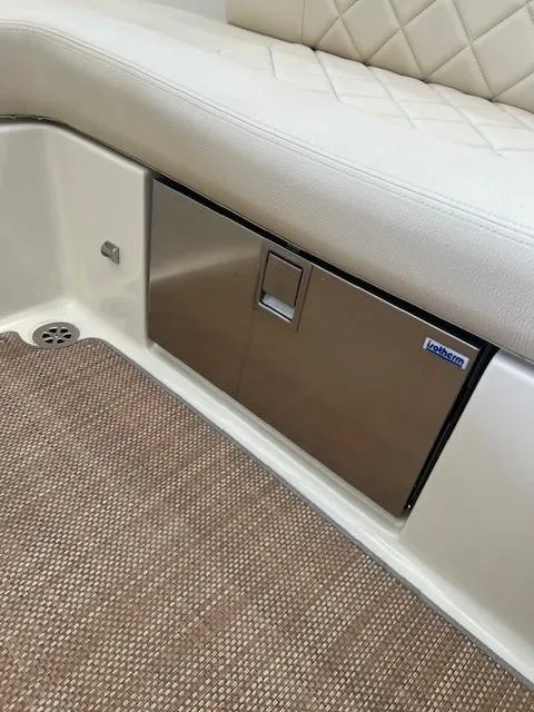 Slide: The Image of 2018 Chris-Craft Launch 27 interior with stainless steel compartment and cushioned seating. - 12