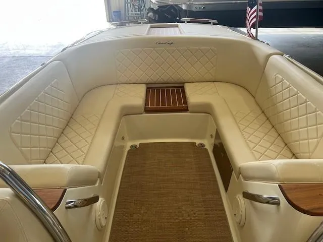 Slide: The Image of 2018 Chris-Craft Launch 27 boat interior with elegant quilted seating and wooden accents. - 16
