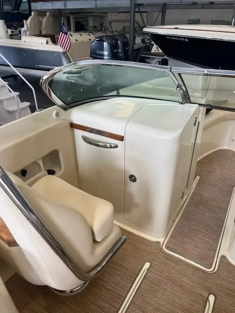 Slide: The Image of 2018 Chris-Craft Launch 27 interior with beige seating and sleek design. - 19