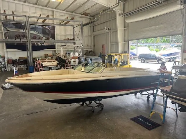 Slide: The Image of 2018 Chris-Craft Launch 27 boat in a spacious indoor garage setting. - 2