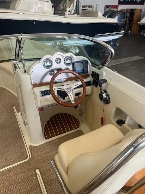 Slide: The Image of 2018 Chris-Craft Launch 27 boat interior with steering wheel and dashboard controls. - 20