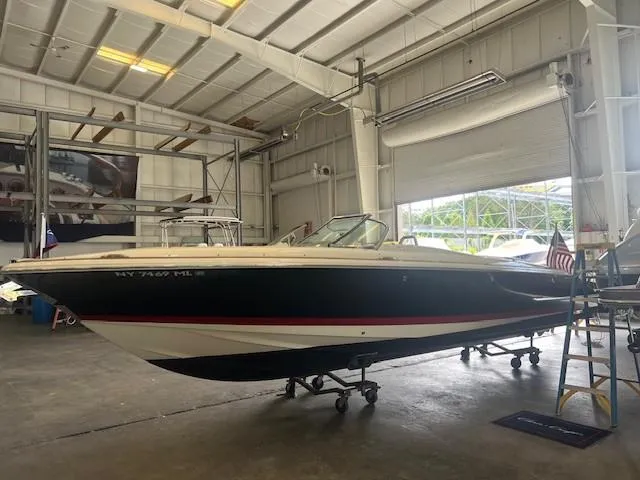 Slide: The Image of 2018 Chris-Craft Launch 27 boat in a spacious indoor storage facility. - 3