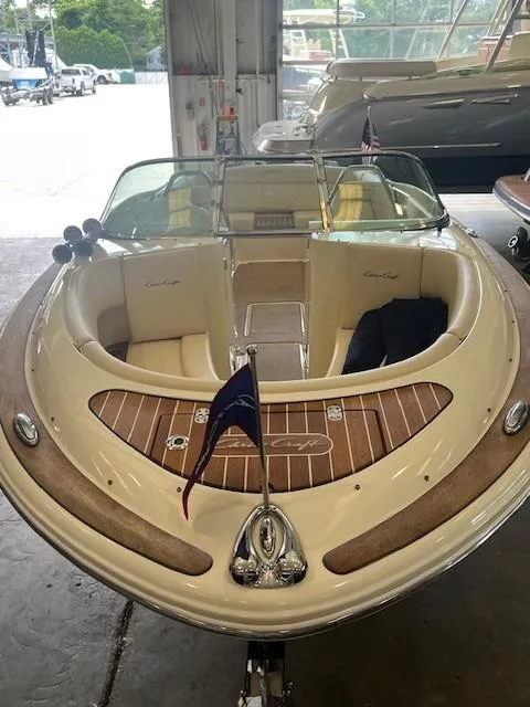 Slide: The Image of 2018 Chris-Craft Launch 27 boat with elegant wood accents in a showroom. - 4