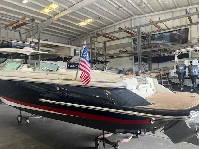 Slide: The Image of 2018 Chris-Craft Launch 27 boat in a storage facility, featuring sleek design and American flag. - 6