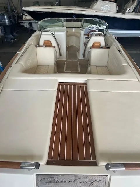 Slide: The Image of 2018 Chris-Craft Launch 27 boat interior with elegant seating and wooden deck. - 8