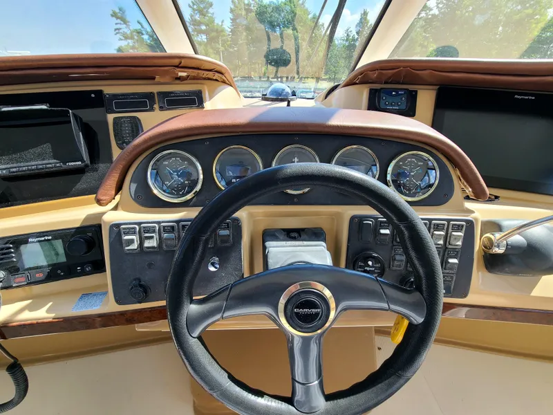 Slide: The Image of 2001 Carver 506 Motor Yacht helm with steering wheel and instrument panel. - 14
